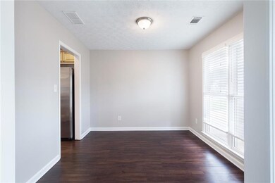 Spare room with dark wood finished floors and a textured ceiling