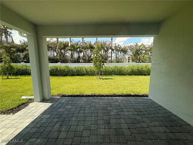Covered lanai with landscaped backyard view