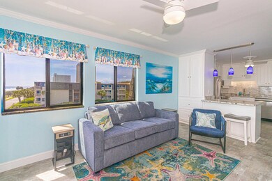 Living area featuring a ceiling fan, plenty of natural light, crown molding, and light wood-type flooring
