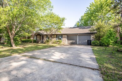 Ranch-style home with concrete driveway, a front l