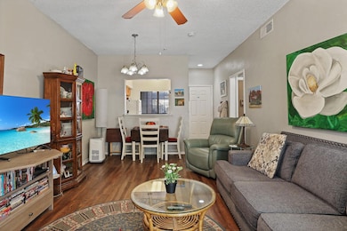 Living room featuring ceiling fan with notable cha