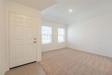 Entrance foyer featuring light colored carpet