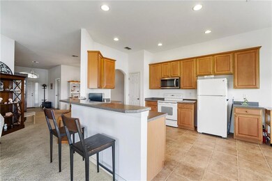 Kitchen featuring a kitchen bar, kitchen peninsula