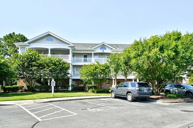 View of building exterior with uncovered parking