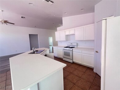 Kitchen with a sink, visible vents, white applianc