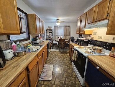 Kitchen with electric range oven, under cabinet ra