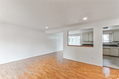 A stunning view from the upper living space overlooks the kitchen and dining areas.
