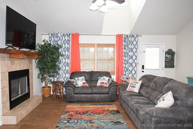 Living room featuring wood finished floors, lofted