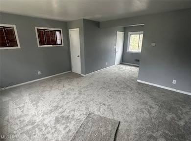 Spare room with carpet floors and baseboards