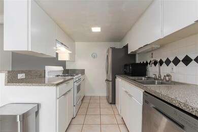 Kitchen featuring white gas range, stainless stee