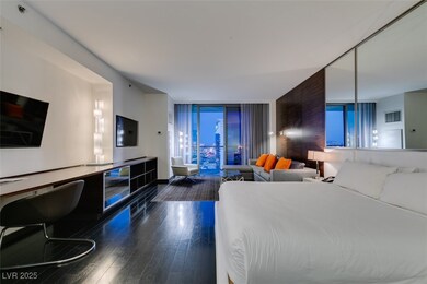 Bedroom with wood finished floors and expansive wi