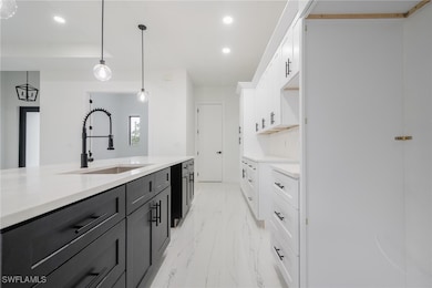 Kitchen with light marble finish flooring, recesse