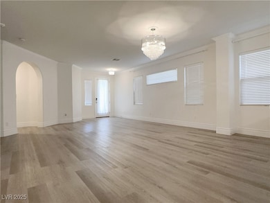 Spare room featuring light wood-type flooring, bas