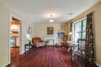 Room to the right of the entry way that could be a sitting room, dining room, second living, or office.