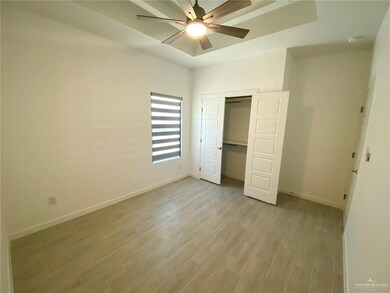 Unfurnished bedroom featuring light wood finished floors, baseboards, a closet, and a ceiling fan