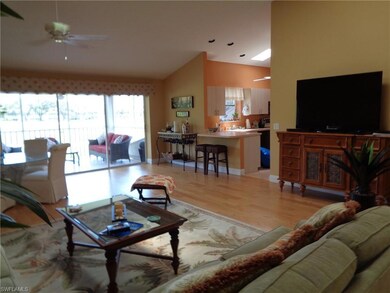 Living room with wood-type flooring, ceiling fan, 