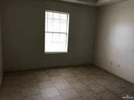 Spare room with light tile patterned flooring