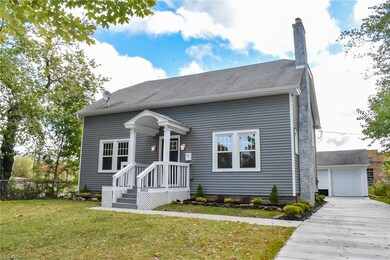 A newer concrete driveway and walkway take you to 
