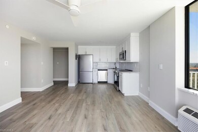 Kitchen with tasteful backsplash, white cabinetry,