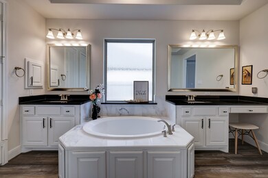Luxurious primary bath with dual vanities, soaking tub, and separate walk in shower!