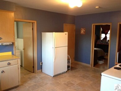 View of kitchen with back facing dining room.