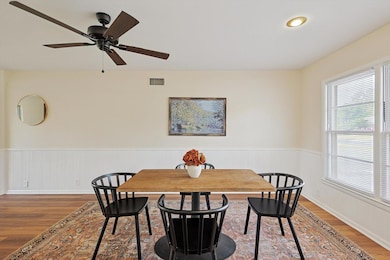 Dining area with hardwood / wood-style flooring and ceiling fan