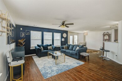 The spacious living room features warm wood-look f