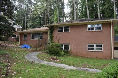View of home's exterior with brick siding, a lawn, and cooling unit