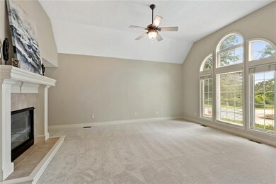 The great room is spacious and includes a vaulted 
