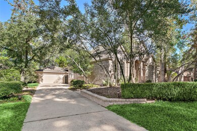 Wide driveway leads to the oversized garage with w