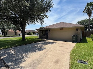 View of front of house featuring concrete driveway, a garage, and a shingled roof