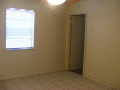 Unfurnished room with a ceiling fan and baseboards