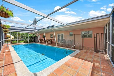 View of pool featuring glass enclosure and a patio