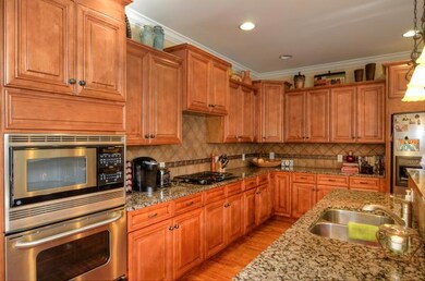 Gourmet kitchen with granite countertops, custom tile back splash, and stainless appliances.  The large island is an entertainers dream allowing for additional serving space and ease of flow.