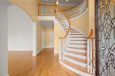 Entrance foyer with a high ceiling, crown molding,