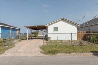 View of property exterior featuring fence and a carport