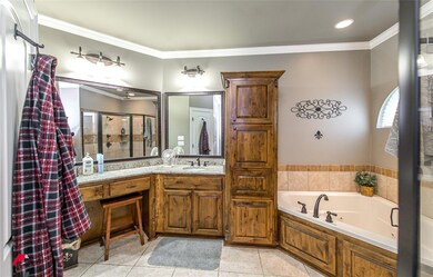 Bathroom with ornamental molding, vanity, shower with separate bathtub, and tile floors