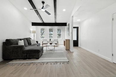 Living area with ceiling fan, light wood finished