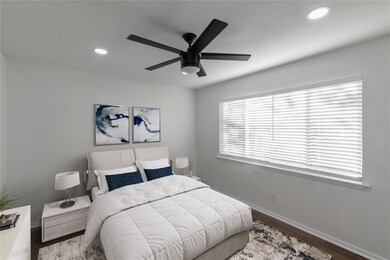 Bedroom featuring ceiling fan and dark wood-type f