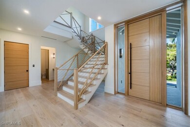 Inside Entryway featuring custom staircase.