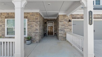 Entrance to property featuring visible vents, a po