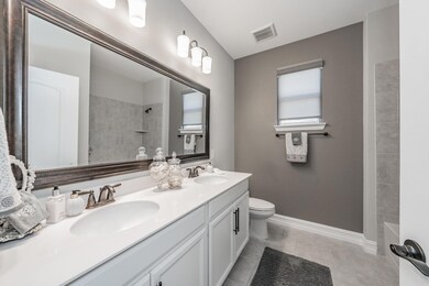 Full bath with shower tub/shower to the right of t