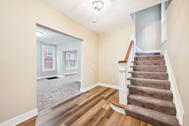 Stairs to 2nd level and Living Room