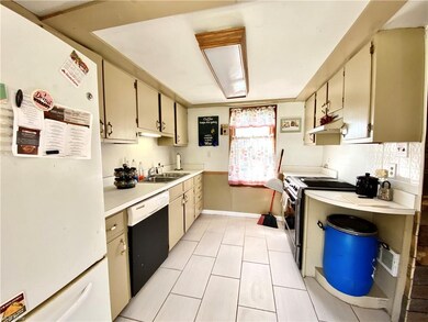 Kitchen with sharp new flooring, stove and dishwas