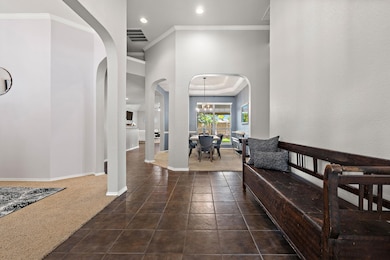 Foyer with arched walkways, recessed lighting, cr