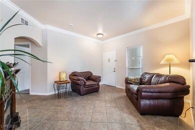 Living room with ornamental molding, visible vents