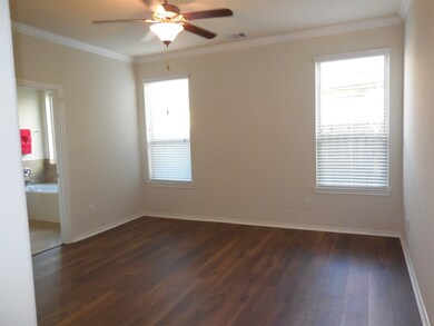 Primary bedroom with new rich walnut luxury engineered vinyl plank flooring.