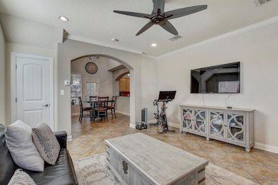 Living area featuring visible vents, a ceiling fa
