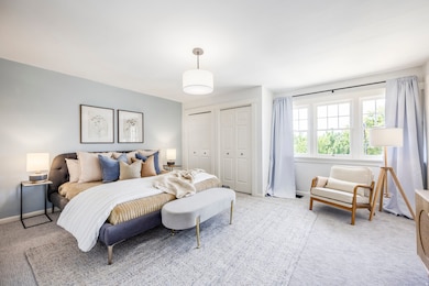 Bedroom featuring two closets and carpet floors