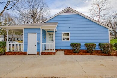 Ample parking in driveway and side entry door goin